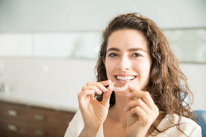 Woman with clear aligners available from T-Town Smiles